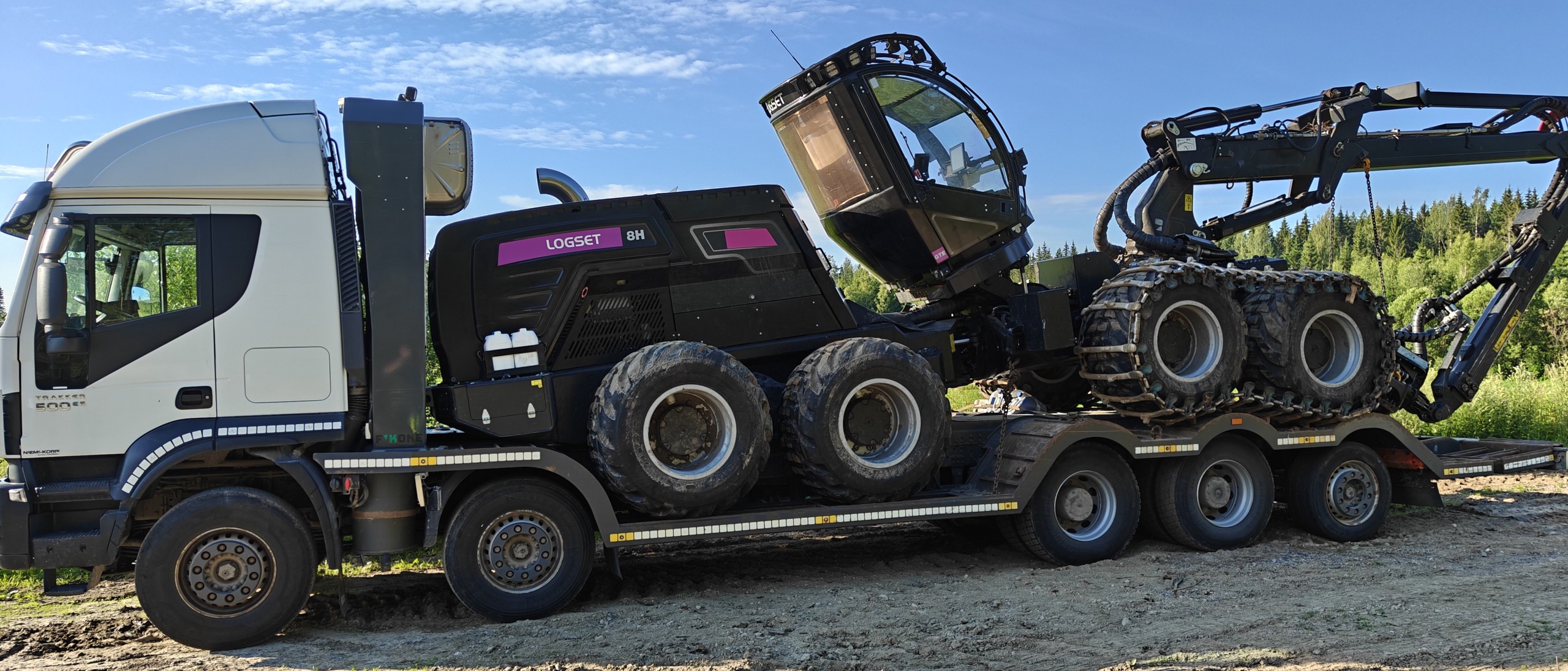 Iveco-kuorma-auto kuljettaa Logset-metsäkonetta lavetilla